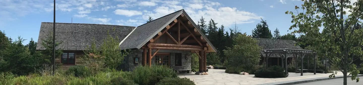A panoramic view of a Ranger Station with bus stop and public restrooms in background.